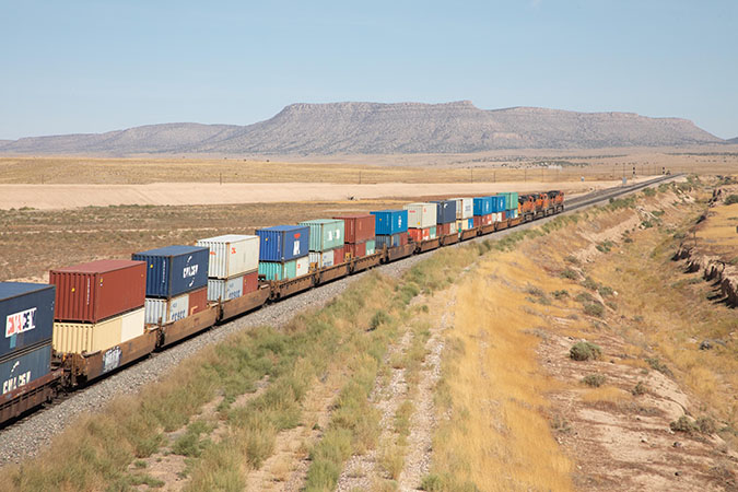 A BNSF intermodal train with stacks of containers 
